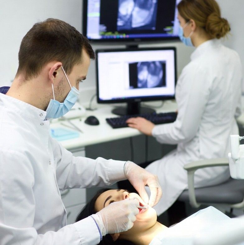 dentist and it technician working together in dental clinic